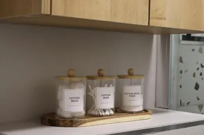 three candles sitting on a shelf in a kitchen at Fighen Apartment in Budva