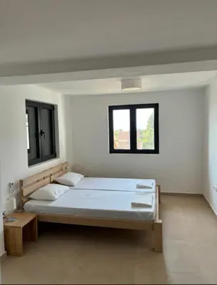 a white room with a bed and a window at B&K Villa Kruče Rooms in Ulcinj