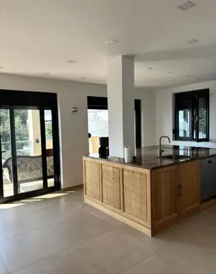 a kitchen with a wooden island in a room at B&K Villa Kruče Rooms in Ulcinj