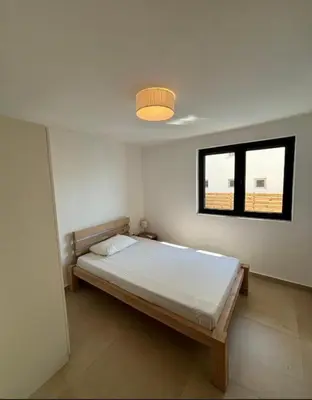 a bedroom with a bed and a window at B&K Villa Kruče Rooms in Ulcinj