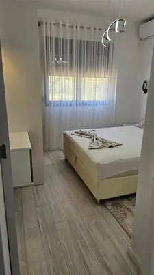 a bedroom with a bed and a window at Apartments Liards in Ulcinj