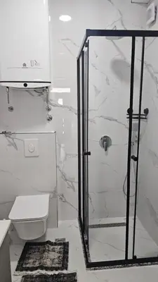 a bathroom with a shower and a toilet at Apartments Liards in Ulcinj