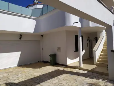a house with a staircase and a garage at Laguna in Donji Štoj