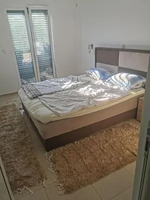 a bed sitting in a room with a window at Laguna in Donji Štoj