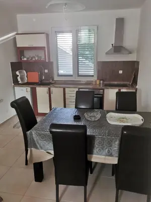 a kitchen with a dining room table and chairs at Laguna in Donji Štoj