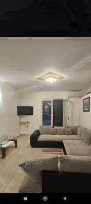 a living room with a couch and a tv at Laguna in Donji Štoj