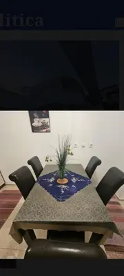 a table with chairs and a potted plant on it at Laguna in Donji Štoj
