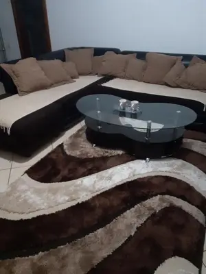 a living room with a couch and a glass table at Studio Apartmani Delić