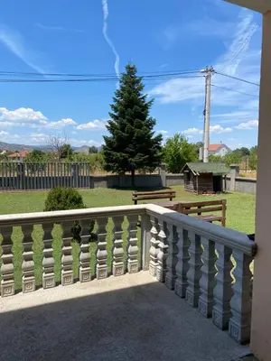 a balcony with a fence and a pine tree at Studio Apartmani Delić