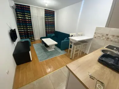 a living room with a couch and a table at Apartman Podgorica in Podgorica