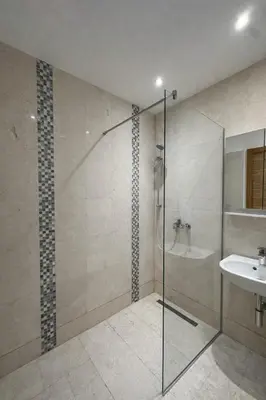 a bathroom with a glass shower and a sink at Libertina Rafailovici in Rafailovici