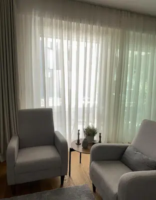 a living room with a couch and a chair and a window at Libertina Rafailovici in Rafailovici