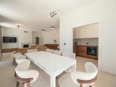 a living room with a white table and chairs at Villa Zvis Sea View with Private Pool & Peaceful Stay in Budva
