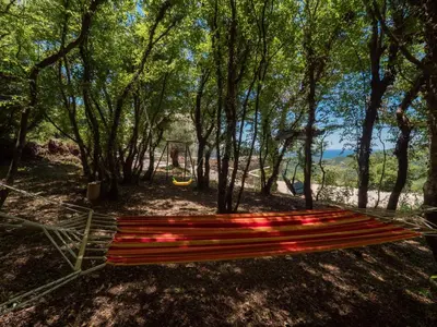 a bench in a park with trees and a playground at Villa Zvis Sea View with Private Pool & Peaceful Stay in Budva