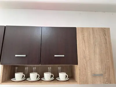 a cupboard with four coffee cups and saucers at Apartment Matija in Cetinje