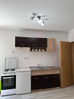 a kitchen with a white stove and a sink at Apartment Matija in Cetinje