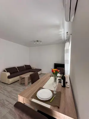a living room with a table and a couch at Apartment Matija in Cetinje