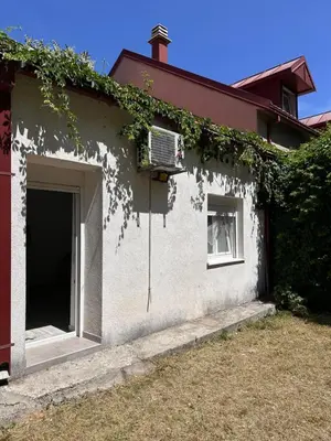 a building with a garage and ivy growing on it at Apartment Matija in Cetinje