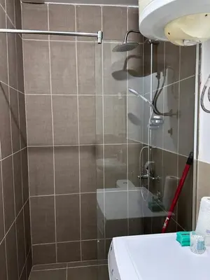a bathroom with a shower with a toilet and a sink at Apartment Matija in Cetinje