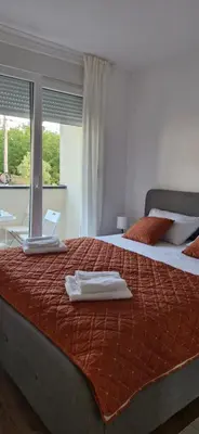 a bedroom with two beds with towels on top of them at kotor apartman 3 in Kravlja