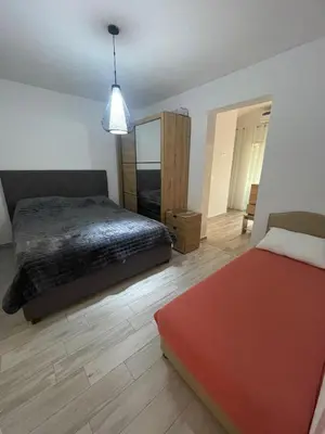a bedroom with a bed and a red ottoman at Asijaapartmani in Bar