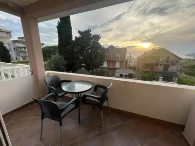 a balcony with a table and chairs and a view at Asijaapartmani in Bar