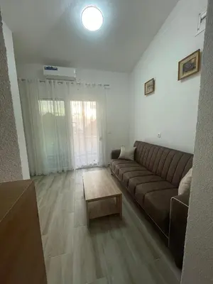 a living room with a couch and a coffee table at Asijaapartmani in Bar