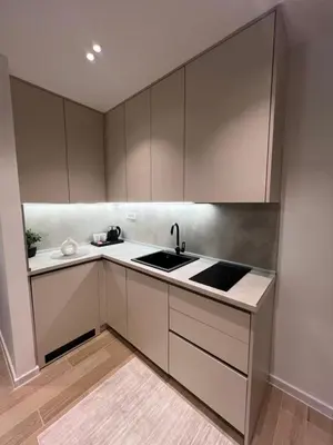 a kitchen with white cabinets and a sink at Dani Deluxe Apartments in Ulcinj