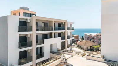 an apartment building with a view of the ocean at Dani Deluxe Apartments in Ulcinj