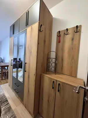 a room with wooden cabinets and a glass door at Stan na dan, Stari aerodrom! in Podgorica