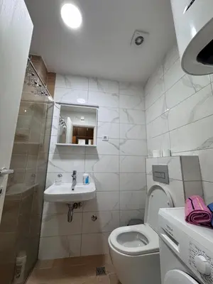 a small bathroom with a toilet and a sink at Stan na dan, Stari aerodrom! in Podgorica