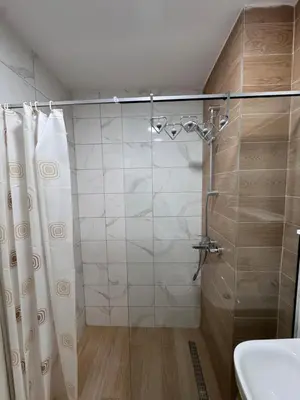 a bathroom with a shower with a shower curtain at Stan na dan, Stari aerodrom! in Podgorica
