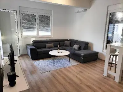 a living room with a couch and a table at Montenegro Ulcinj Apartments in Kravlja