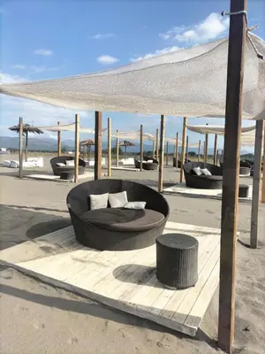 a circular seating area on a sandy beach with a tent at Montenegro Ulcinj Apartments in Kravlja