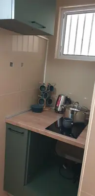 a kitchen with a stove and a counter with pots and pans at Forest Nest Bartula in Bar