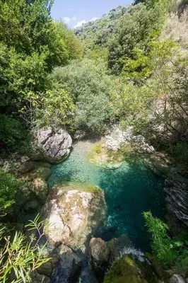 an aerial view of a river with rocks and trees at Forest Nest Bartula in Bar