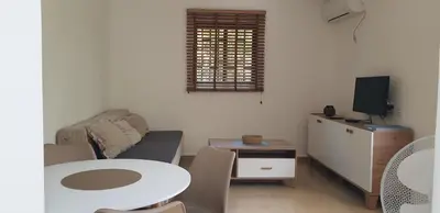a living room with a table and a couch at Forest Nest Bartula in Bar