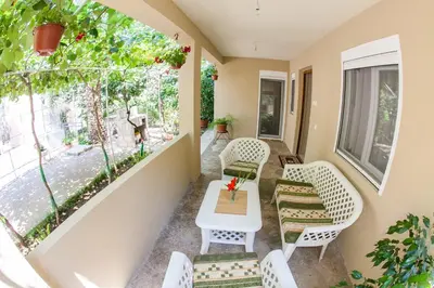 a balcony with chairs and a table and a window at Lidia Apartments in Budva