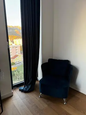 a blue chair sitting in front of a window at Soho CIty 808A in Bar