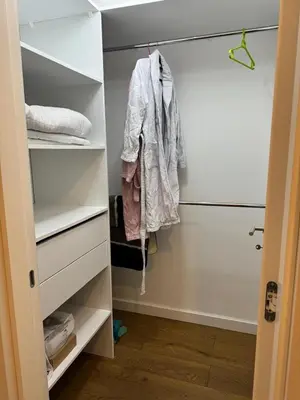 a walk in closet with a robe hanging in it at Soho CIty 808A in Bar