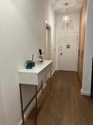 a hallway with a white table and a white door at Soho CIty 808A in Bar