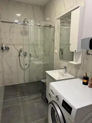 a bathroom with a glass shower and a sink at Soho CIty 808A in Bar