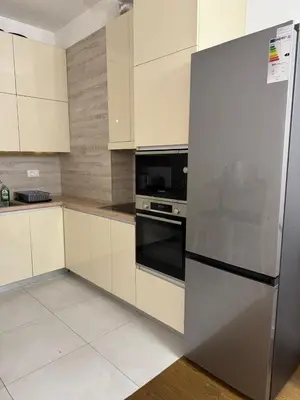 a kitchen with a stainless steel refrigerator and white cabinets at Soho CIty 808A in Bar