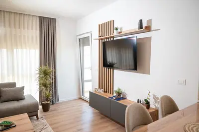a living room with a television on a wall at AndArt Heaven in Ulcinj