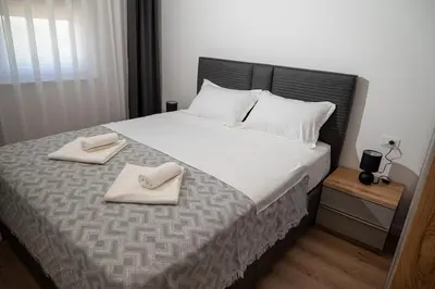 a bedroom with a large bed with two towels on it at AndArt Heaven in Ulcinj