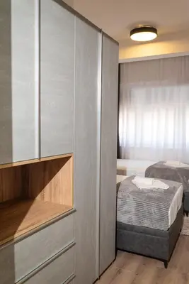 a small bedroom with a bed and a closet at AndArt Heaven in Ulcinj
