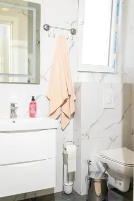 a bathroom with a sink and a toilet and a mirror at AndArt Heaven in Ulcinj