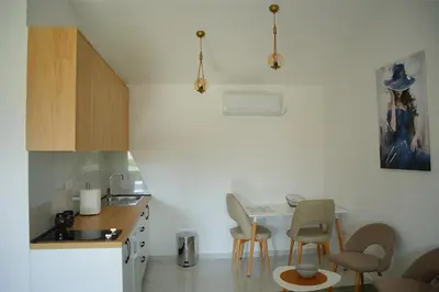 a small kitchen with a table and chairs in it at The River Studio Beli in Podgorica