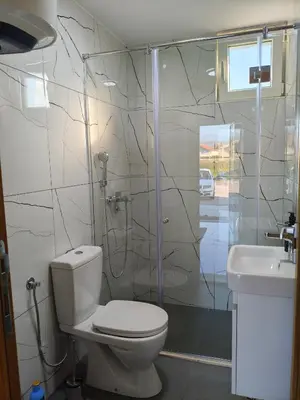 a bathroom with a toilet and a shower and a sink at The River Studio Beli in Podgorica