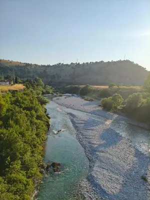 a view of a river with rocks and trees at The River Studio Beli in Podgorica